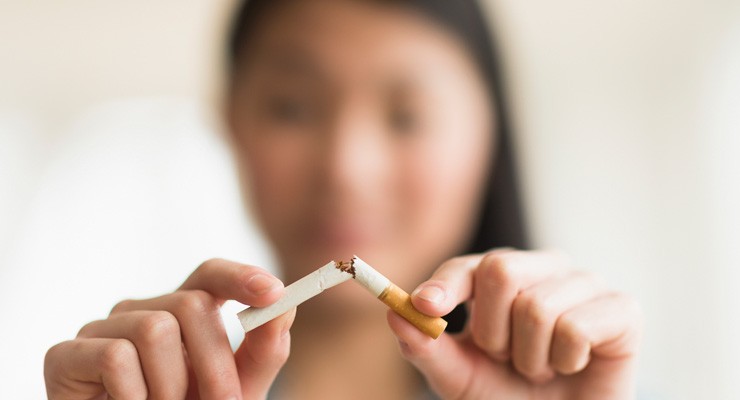 image of woman breaking a cigarette