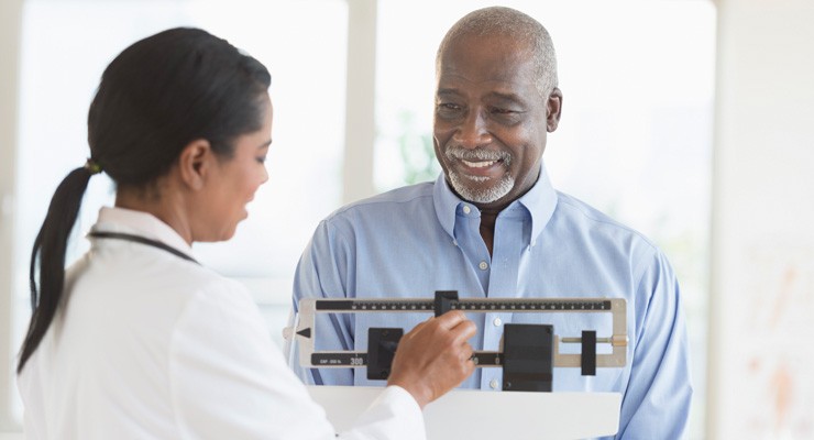 man on scale in doctor's office